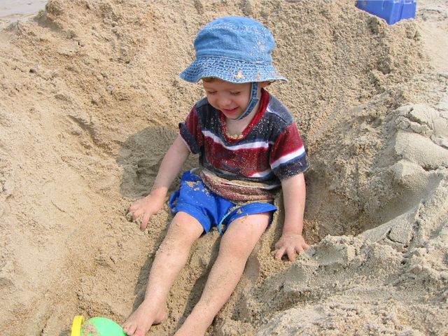 Tyler covered in sand